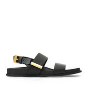 Black sandal with gold buckles on a white background