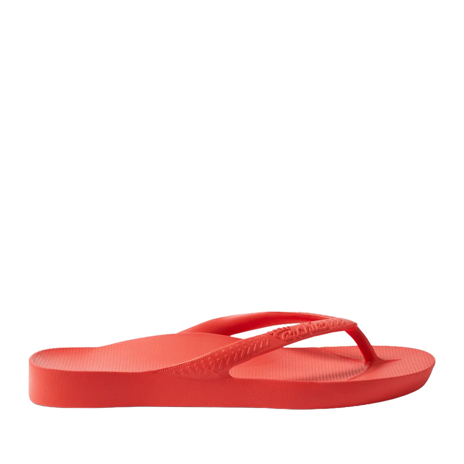 Coral red thong flip flops on a black background