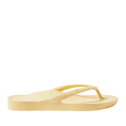 Yellow thong flip flops on a black background