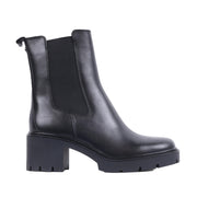 black heeled boot, lug sole, and zipper side closure on a white background