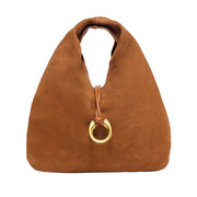 tan suede slouchy top handle pouch bag with gold horseshoe charm on a white background