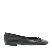 black leather ballet flat with bow detail on a white background