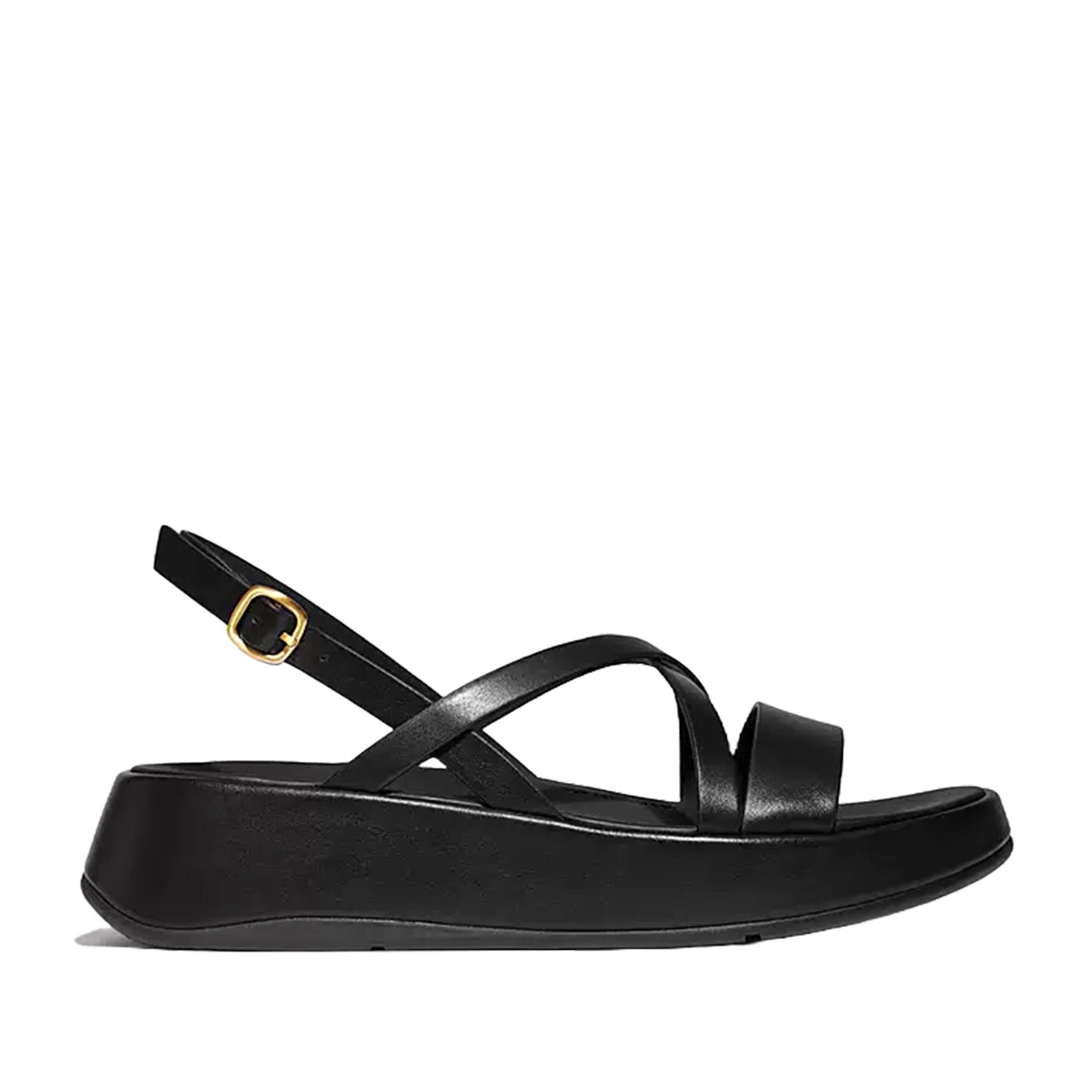 Black leather slingback crisscross sandal with low wedge and gold adjustable buckle. 