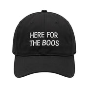 Embroidered black hat with "Here for the boos" on a white background