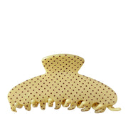 yellow polka dot patterned hair claw clip on a white background