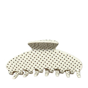 white polka dot patterned hair claw clip on a white background