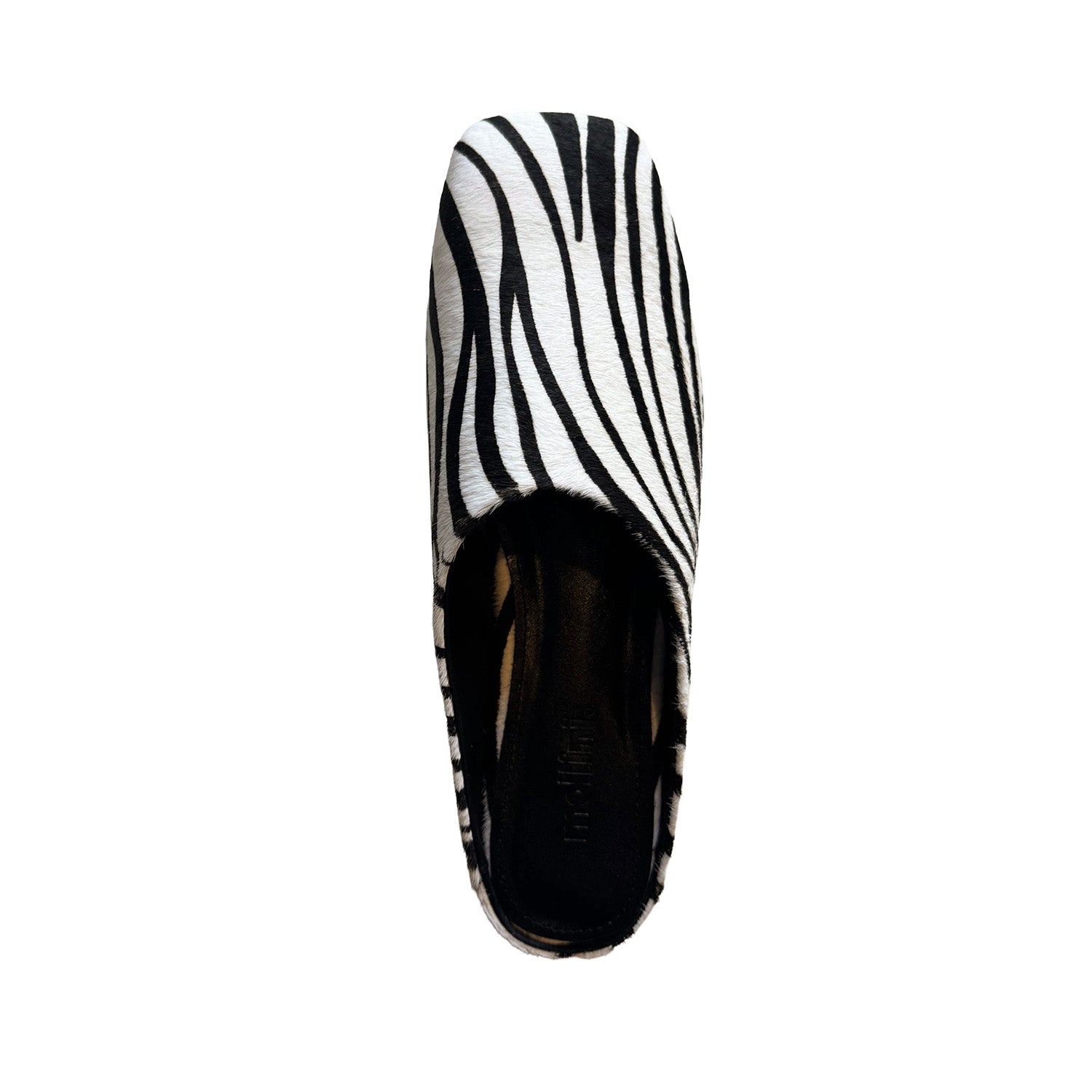 Black and white patterned slip on shoe on a white background