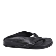 Black leather slip-on flip flop sandal with a twist strap detail on a white background.