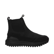 black leather chelsea winter boot with lug sole on a white background
