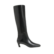 black leather heeled knee high boot on a white background