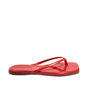 Red leather flip flops with a square toe on white background