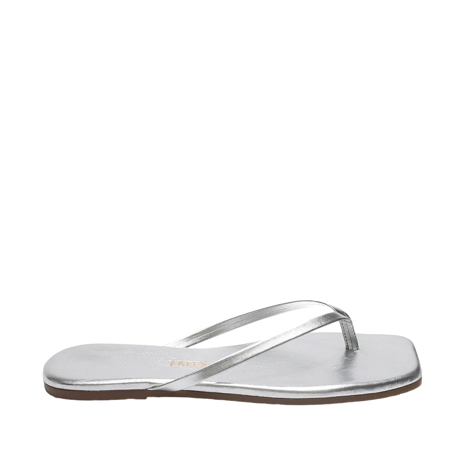 Silver metallic leather flip flops with a square toe on white background