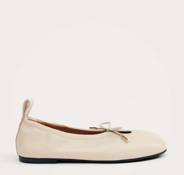 Cream key hole ballet flat on grey background