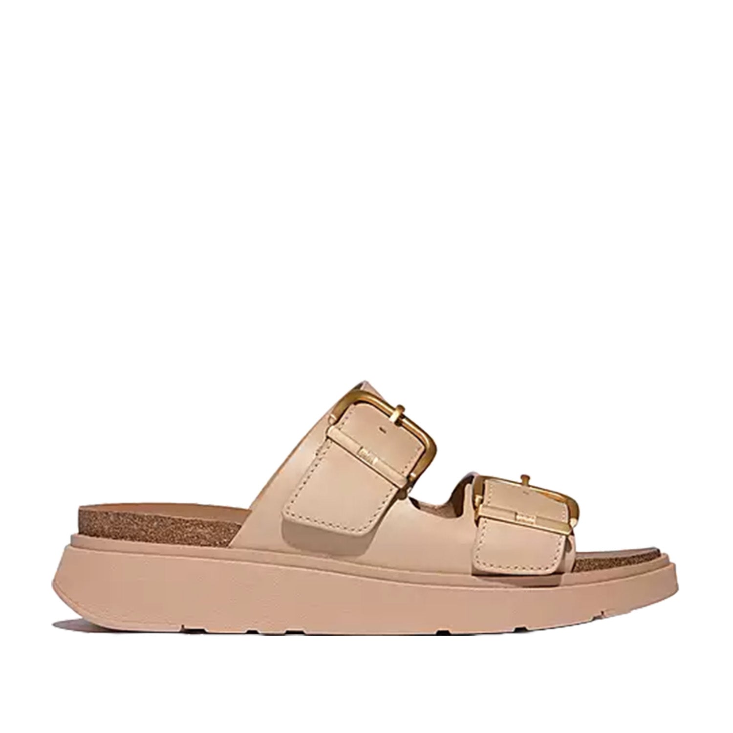 Light tan brown leather double strap slide sandal with large gold buckle details on straps. 