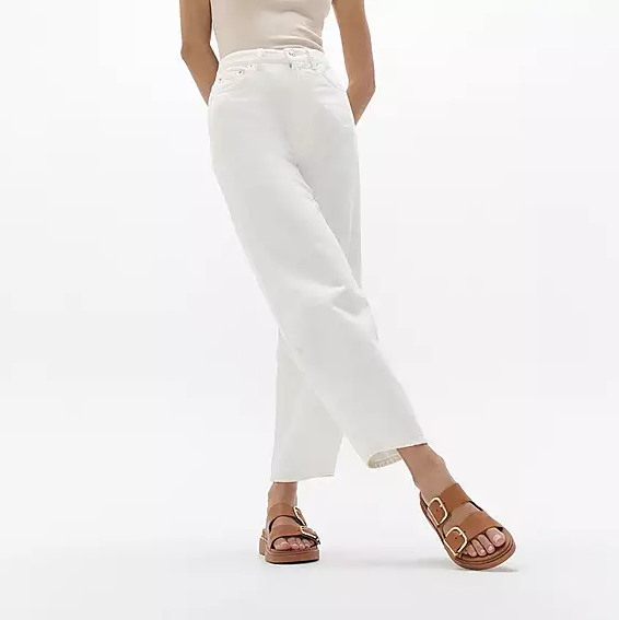 Light brown leather double strap slide sandal with large gold buckle details on straps. 