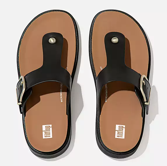 Black leather toe-post sandal with gold buckle. 